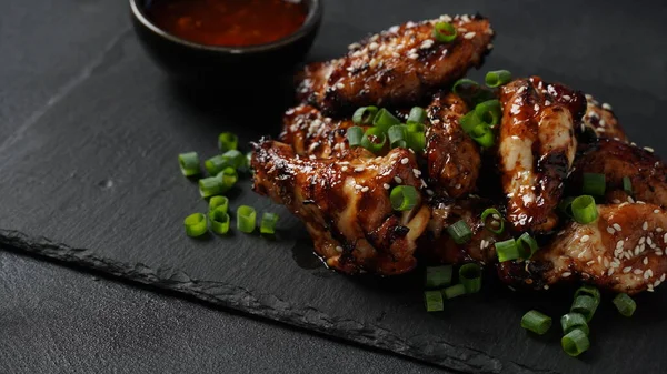 Grilled Chicken Wings Sauce Garnished Green Onions Slate Board Black — Stock Fotó