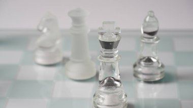 Transparent chess figures, on starting position, on reflective chess board, red tone. Strategic Chess board game