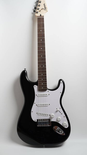 Black and white electric guitar on white background