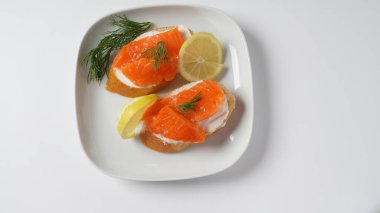 Open sandwiches with trout fillet ,wheat bread with butter and herbs