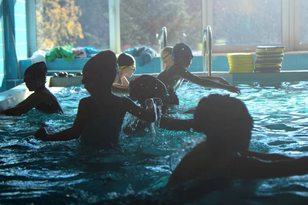 Csoport boldog gyerekek medence osztály tanul úszni — Stock Fotó