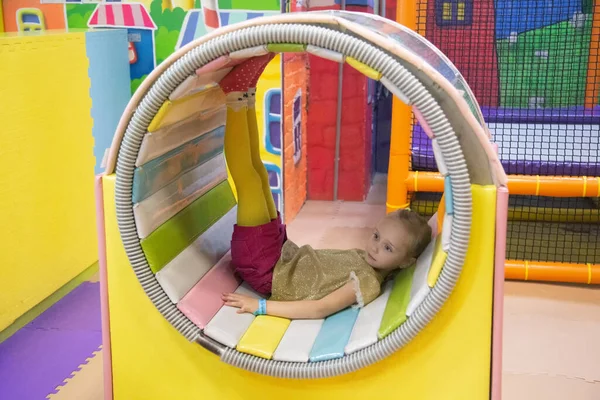 Kid girl have fun in carousel upside down the indoor play center — Stock Photo, Image