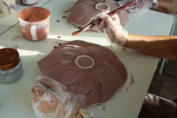 Kvinna hand keramik gör lera monstera löv i keramik verkstad studio. Processen för glasering keramiska vas — Stockfoto