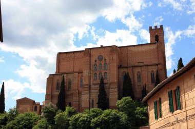 external walls of the monument church of san domenico among the narrow streets of the enchanting medieval siena in tuscany
