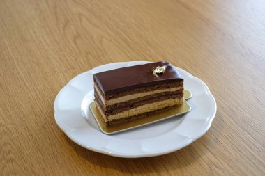 opera cake on white dish. Homemade bakery concept.