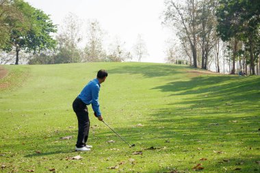 Golf sahasında golf oynayan adam..