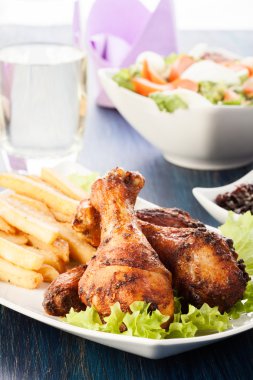 Chicken drumsticks with prepared potatoes clipart