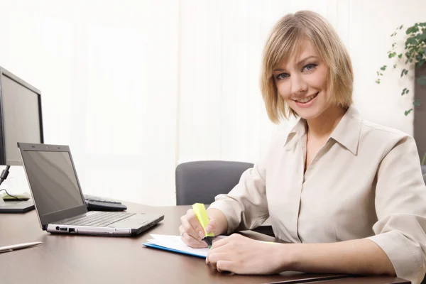 Businesswoman highlighting chart Stock Image