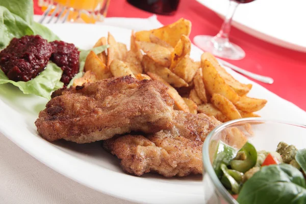 Breaded chop and prepared potatos — Stock Photo, Image