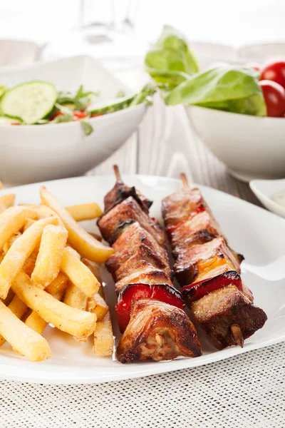 Grilled shashlik with french fries — Stock Photo, Image