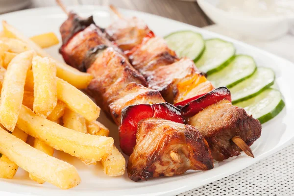 Grilled shashlik with french fries — Stock Photo, Image