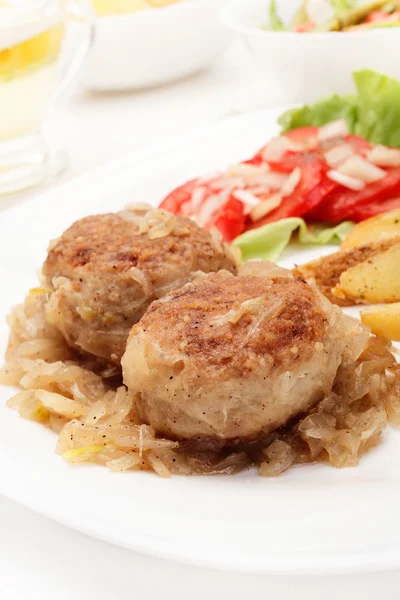 Meatballs with stewed onion and fried potato wedges — Stock Photo, Image