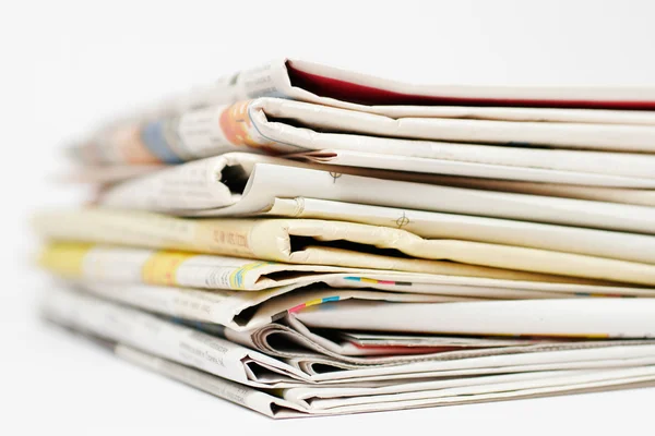 Stack of newspapers on white background — Stock Photo, Image