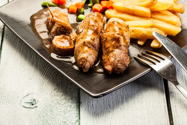 Beef rolls with french fries — Stock Photo, Image