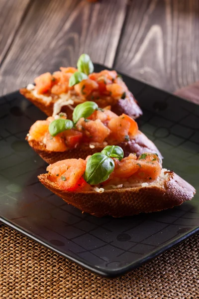 Bruschetta with mozzarella and tomato — Zdjęcie stockowe