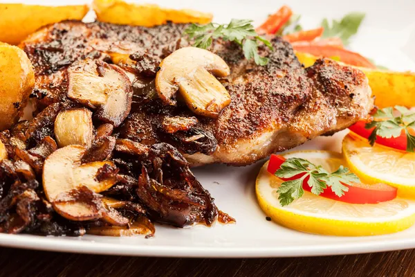 Pork chop with mushrooms and chips — Stock Photo, Image