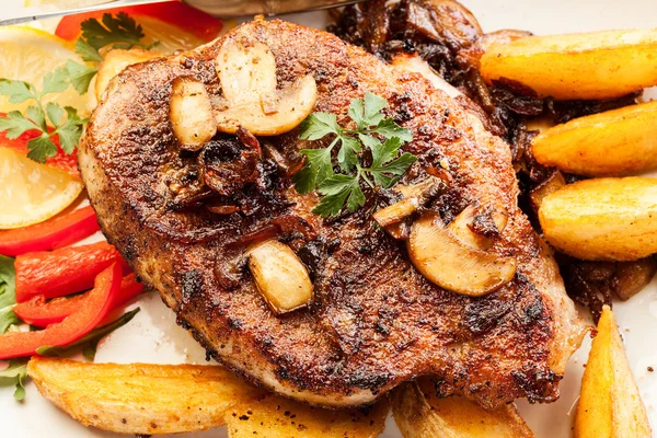 Pork chop with mushrooms and chips — Stock Photo, Image