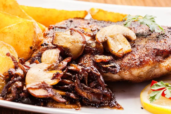 Fried pork chop with mushrooms and chips — Stock Photo, Image