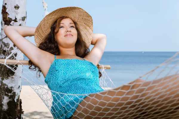 Mulher relaxante na rede na praia — Fotografia de Stock