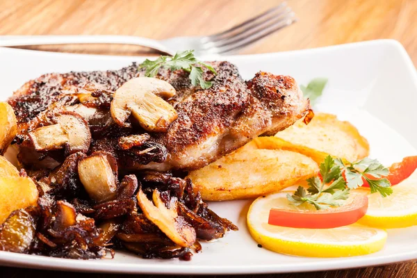 Fried pork chop with mushrooms and chips — Stock Photo, Image