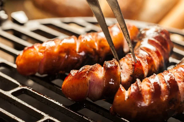 Grilling sausages on barbecue grill — Stock Photo, Image