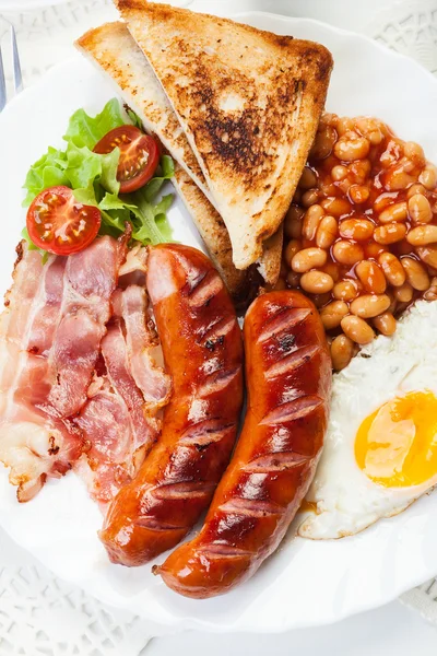 Petit déjeuner anglais complet avec bacon, saucisse, œuf frit et haricots cuits au four — Photo