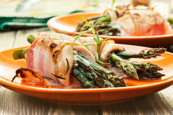 Baked asparagus wrapped in chicken and bacon