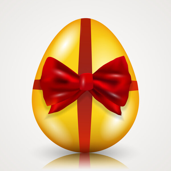 Gold easter egg tied with ribbon and bow