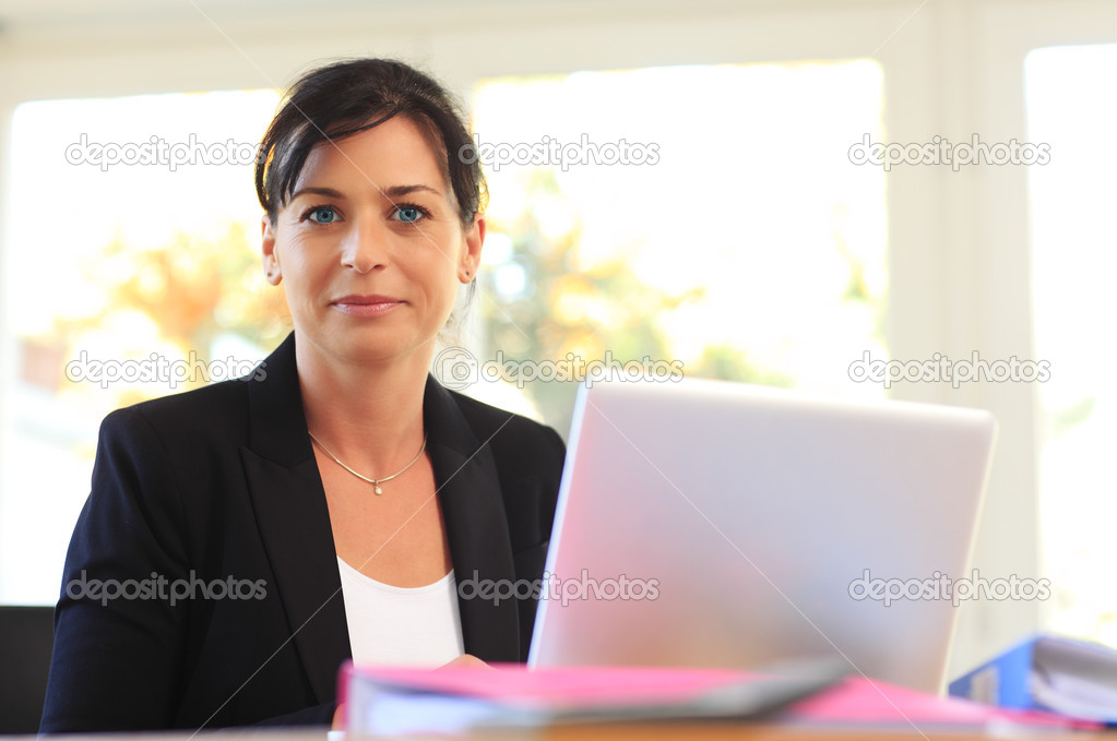 Beautiful business woman with laptop.