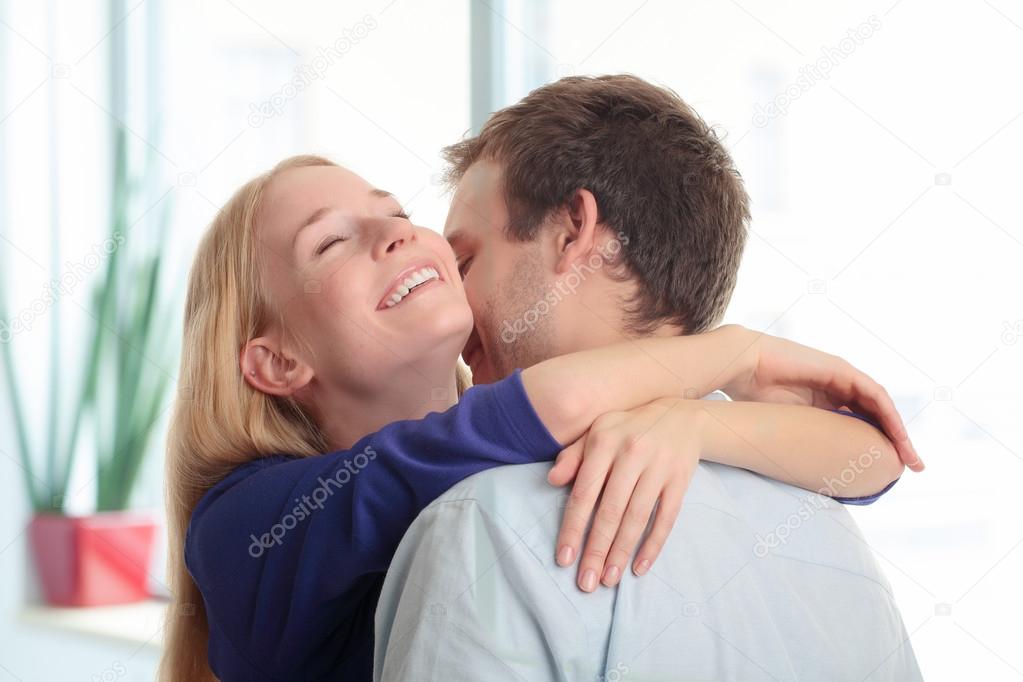 Young woman close her eyes and embracing her boyfriend