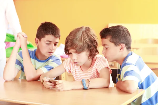Children playing with smartphone — Stock Photo, Image
