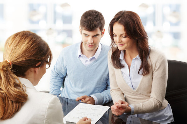 Young couple discussing financial plan with consultat