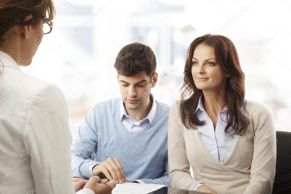 Young couple discussing financial plan with consultat