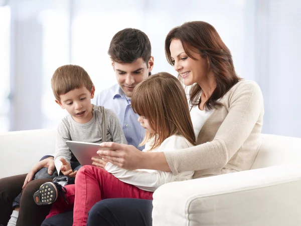 Happy family sitting in living room — Stock Photo, Image