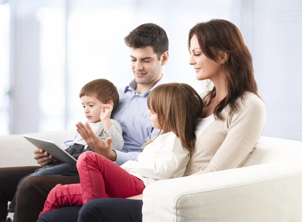 Happy family sitting in living room — Stock Photo, Image