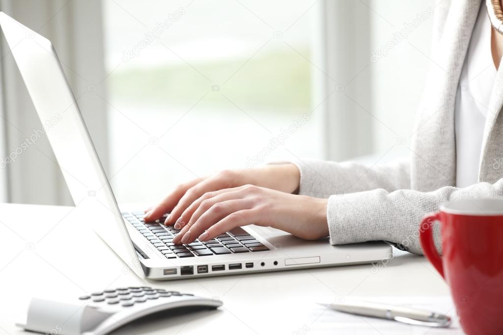 Businesswoman typing on keyboard