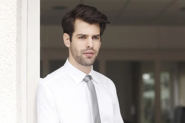 Young businessman standing at office — Stock Photo, Image