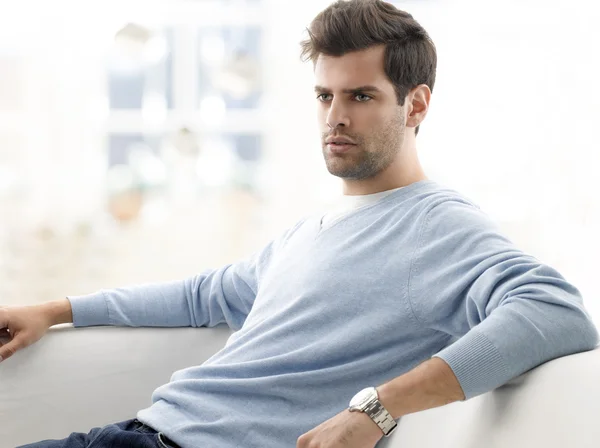 Modern young man relaxing on sofa — Stock Photo, Image