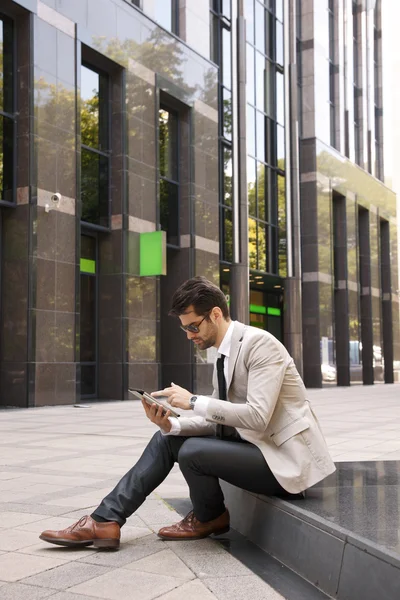 Modern businessman in front of business center — Stock Photo, Image