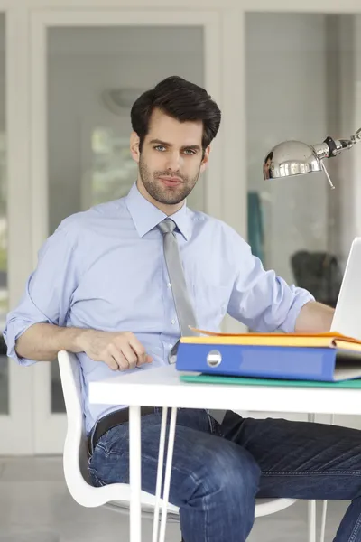 Businessman sitting at office and working — Stock Photo, Image
