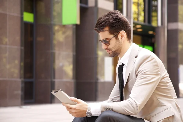 Modern businessman in front of business center — Stock Photo, Image