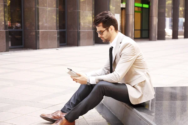 Modern businessman in front of business center — Stock Photo, Image