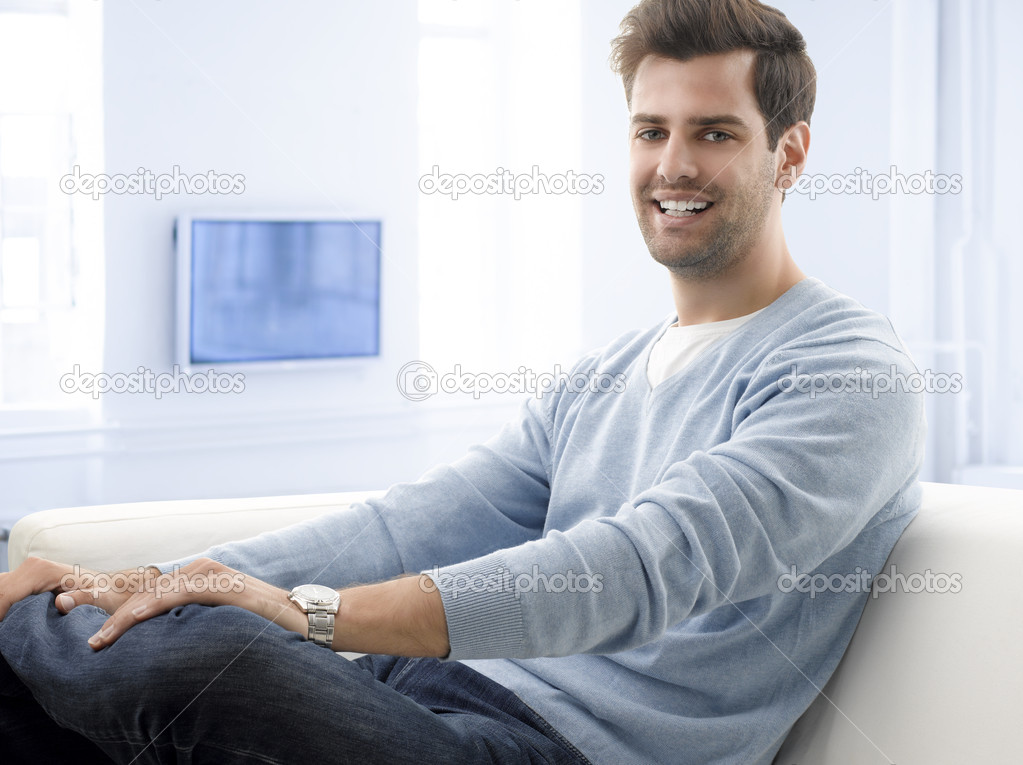 Modern young man relaxing on sofa