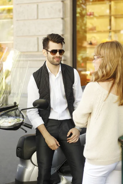 Businessman with scooter discussing with woman — Stock Photo, Image