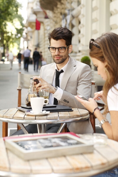 Businessman with businesswoman at coffee shop