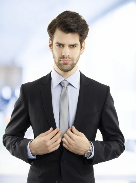 Young businessman standing at office — Stock Photo, Image