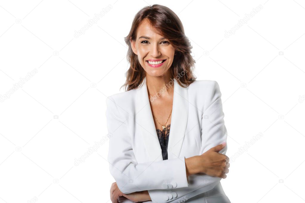 Studio portrait shot of attractive middle aged woman with toothy smile wearing blazer while standing at isolated white background. Copy space. 