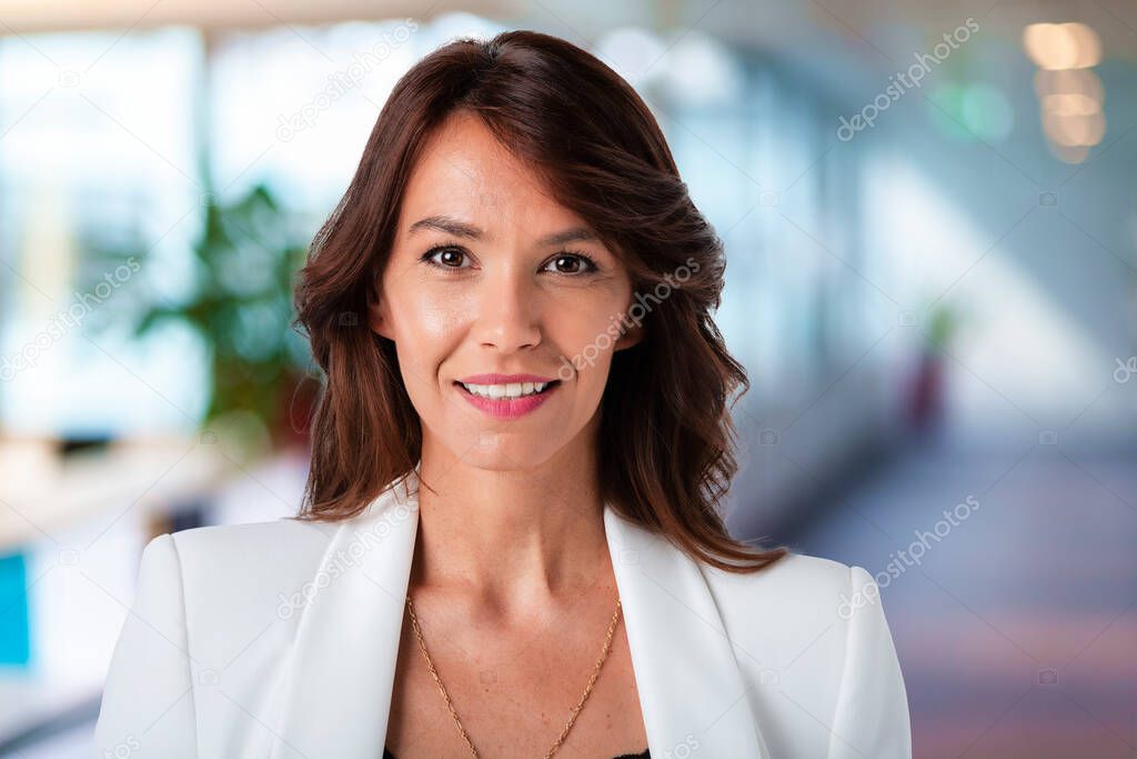 Close-up of an elegant middle aged businesswoman standing in the office.