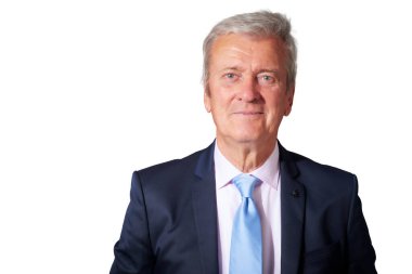 Closle-up studio portrait of grey haired businessman wearing suit while standing at isolated white background. Copy space.