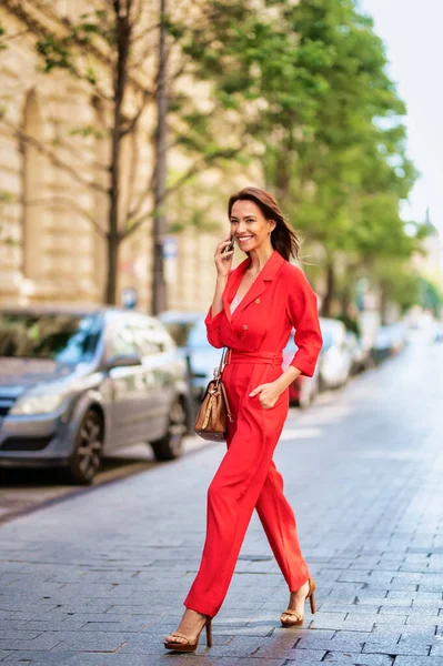 Full Length Smiling Woman Walking Street Using Mobile Phone City - Stock-foto